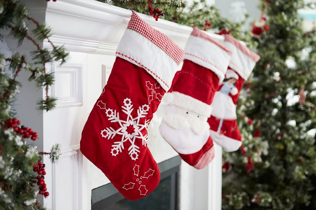 Red stockings on the mantel for a traditional Christmas.