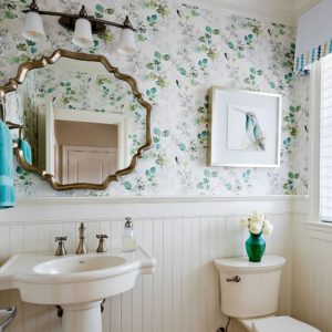 A combination of beadboard trim work and some pretty wallpaper made this small bathroom special.